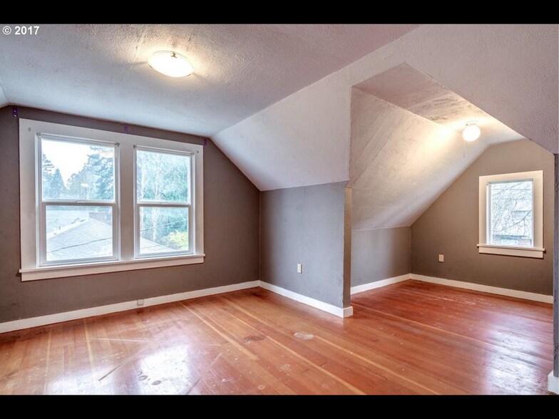 Large Upstairs Bedroom. All floors will be refinished after this photo was taken - 4709 NE 15th Ave