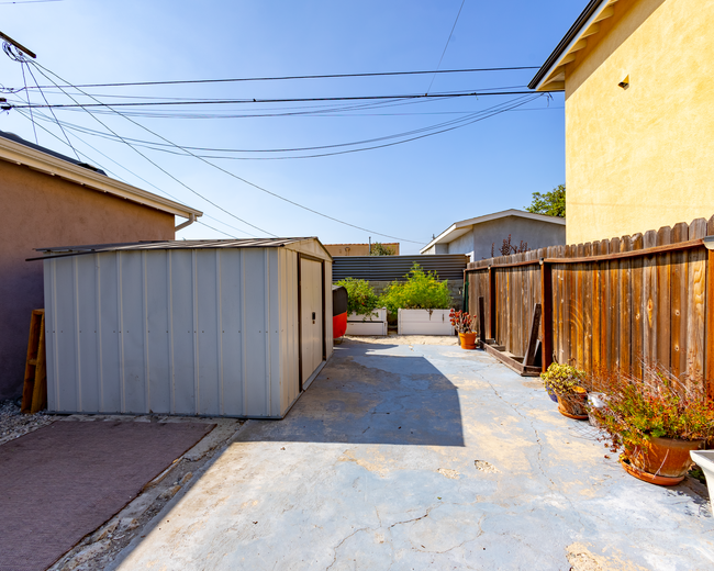 Backyard 4 - ft. garden boxes, ample yard space and storage shed - 6401 Arlington Ave