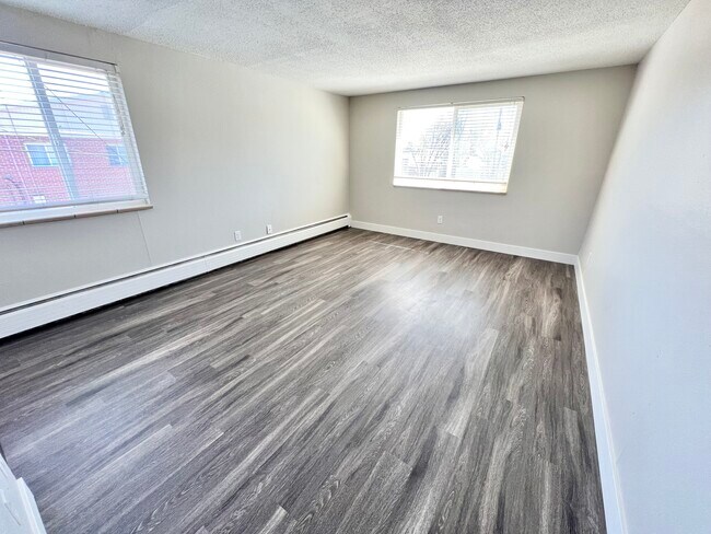 Experience the perfect blend of light and space in this modern room with stylish flooring. - Wadsworth Station West