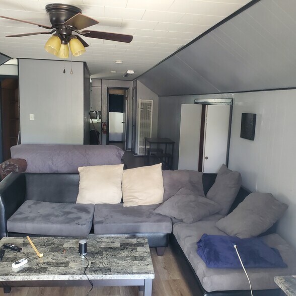 Sectional sofa and futon behind it - 314 Julia St