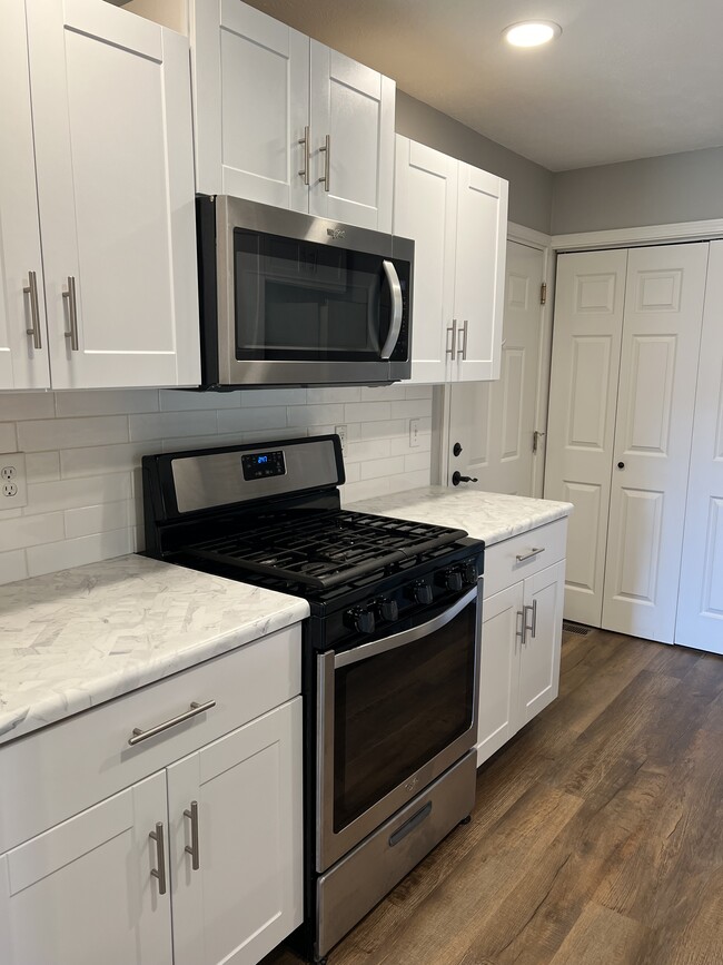 Kitchen with subway tile backsplash and stainless appliances. - 2401 Windward Blvd