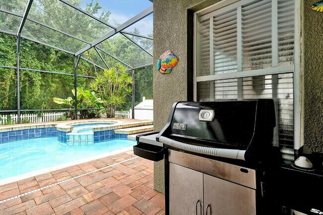 Building Photo - "Stunning 3BR Orlando Home with Private Screened Pool, Spa & Spacious Living Areas"