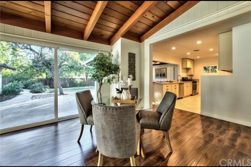 Warm entry opens to spacious living & dining with rich wood beams and natural light - 332 E Deodar St