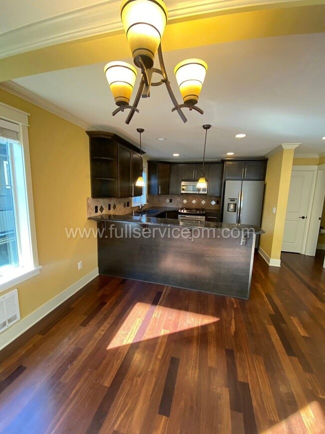 Building Photo - Spacious townhome with private backyard, garage parking, multiple decks, and a dedicated home off...