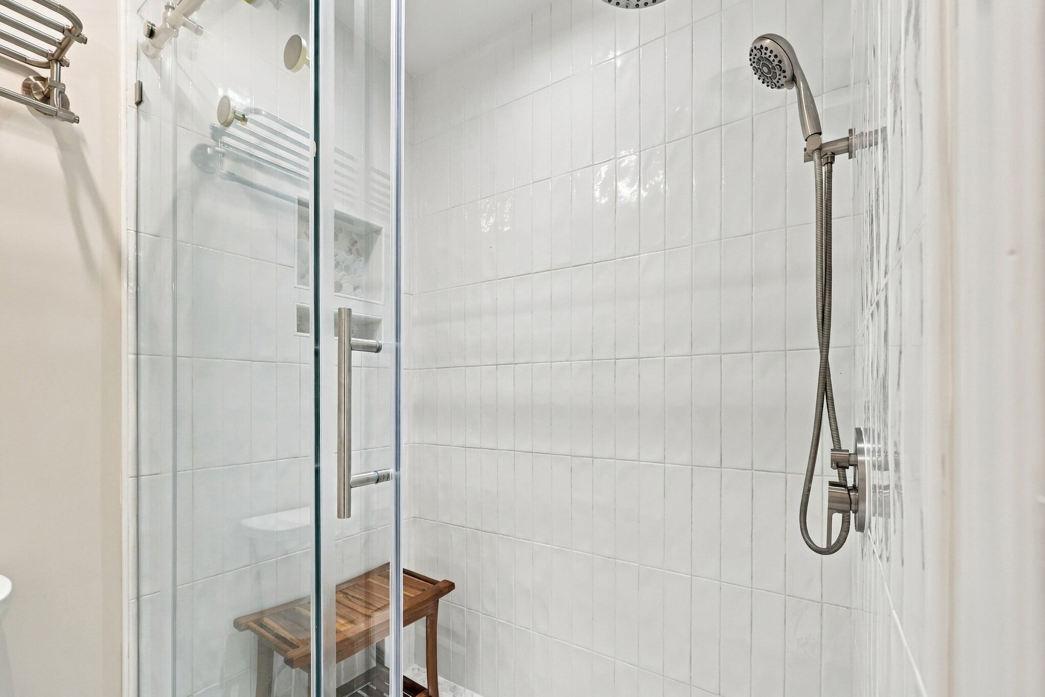 Walk-in shower with tile surround and handheld shower fixture. - 3622 Caroline Vale Blvd