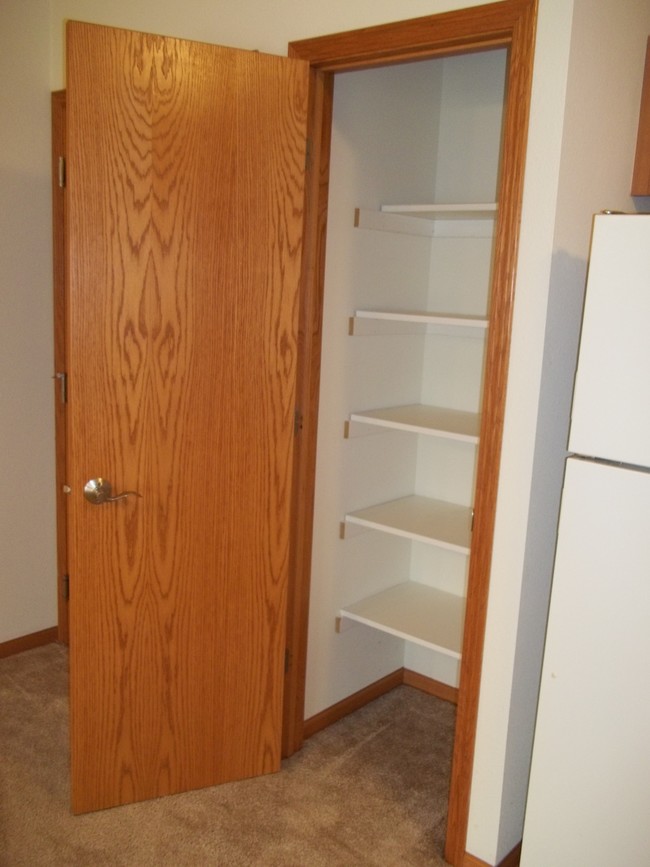 Kitchen pantry with shelving. - Park Creek Apartments