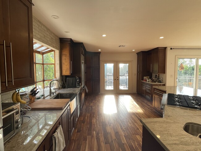 Kitchen with french doors opening to screened in balcony - 1068 E San Jose Ave