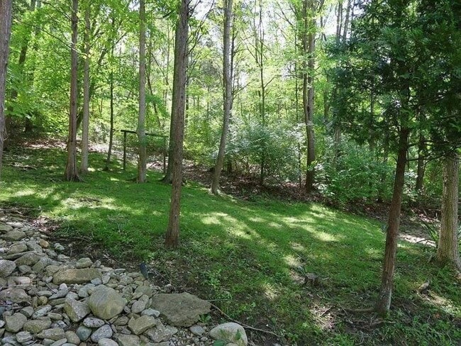 Building Photo - Stunning 4-Bedroom Home with 5 Full Baths + Hot Tub, Wooded Retreat