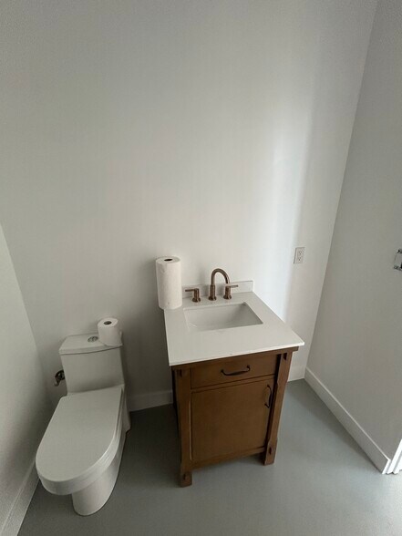 Spacious and efficient bathroom with modern touches and champagne bronze fixtures. - 4435 Radium Dr