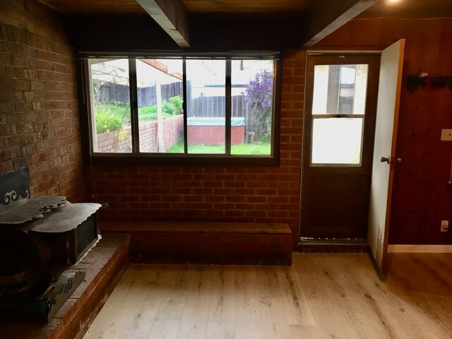 Fireplace with view of backdoor and yard - 995 Nob Hill Ave