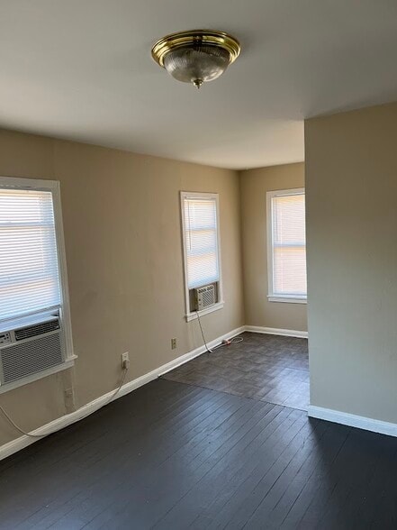 Living room, partial view. Wood floor and linoleum in the kitchen. - 1162 W 24th St