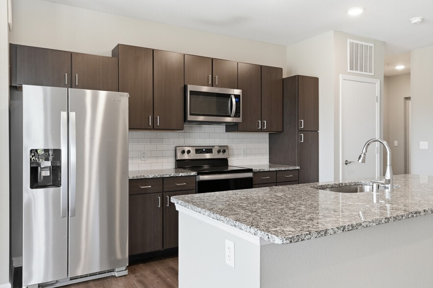 Cook, dine, and gather in a stylish kitchen space. - The Haven