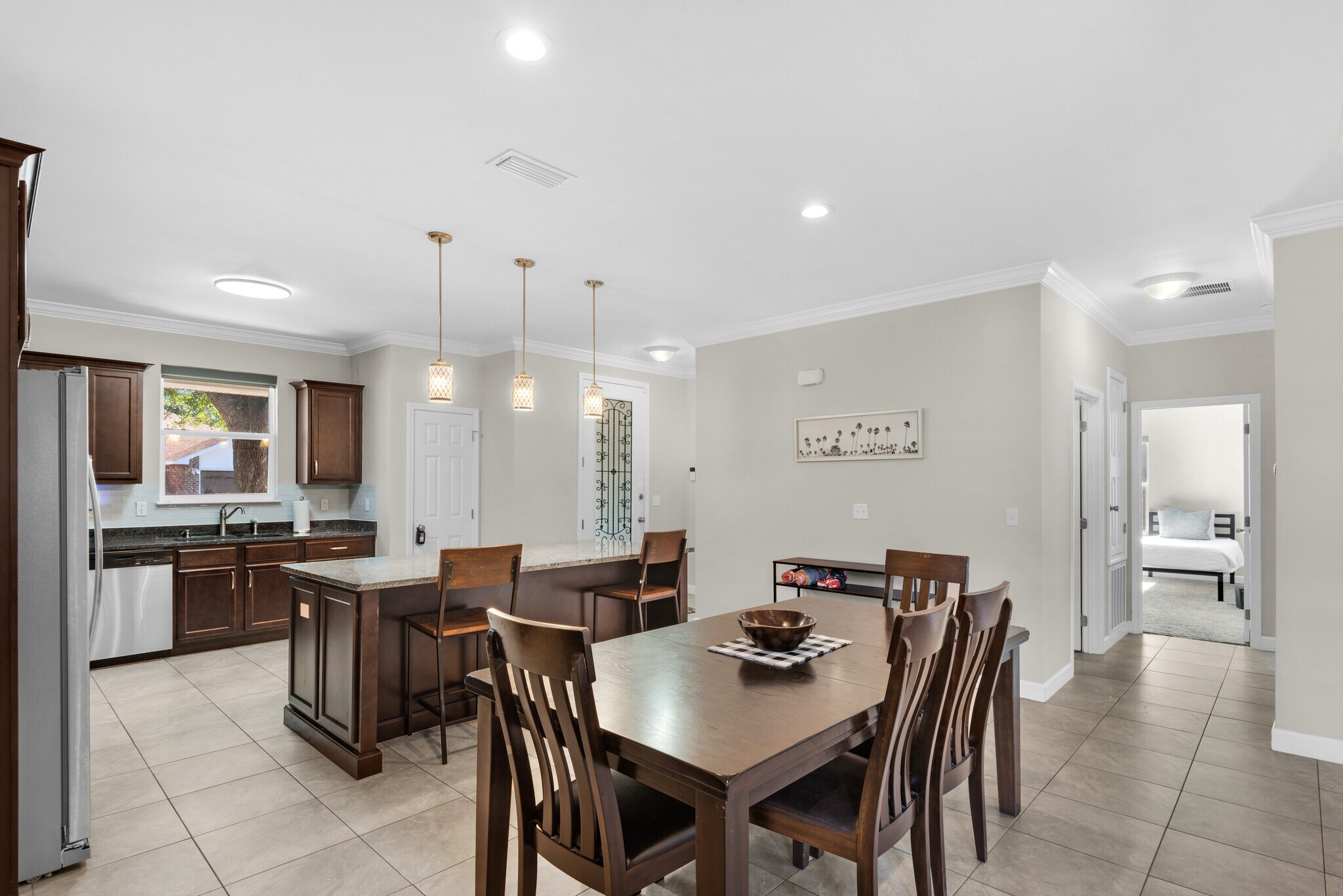 Open space for entertaining, with dining room table, island, and bar cart - 28 Snook Rd