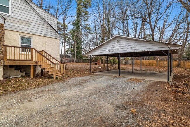 Building Photo - Brick home, Two Story, Hardwoods, DR, 2 Sun Rooms, FP, Carport!.