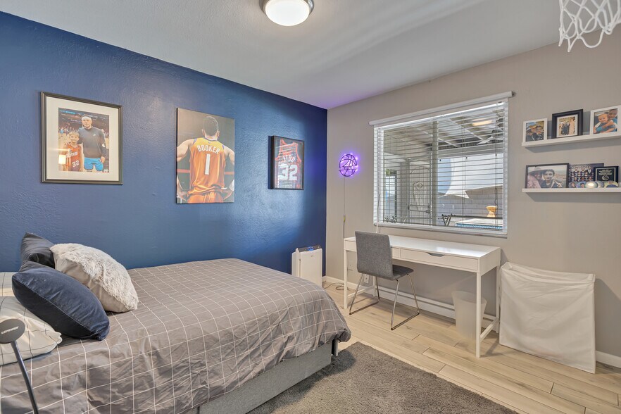 Third bedroom set up with full bed and desk, suitable for guest room or office - 6136 N 9th St