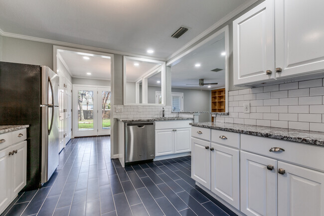 View from kitchen into dining area, 2 more pantries, french doors open to deck - 8738 Glencrest Ln