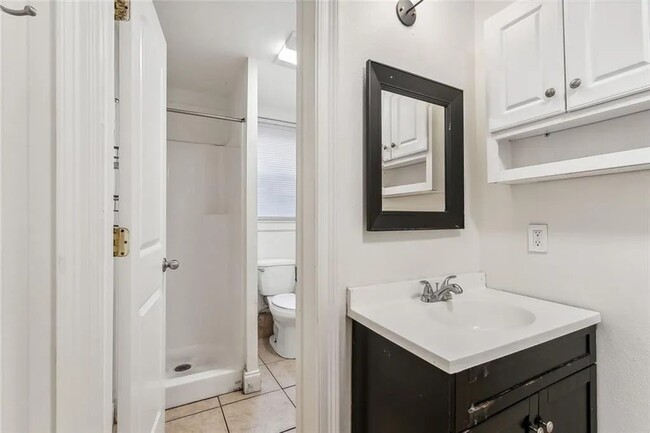 Bathroom 2 includes a shower, toilet and vanity area - 5830 S Robertson St