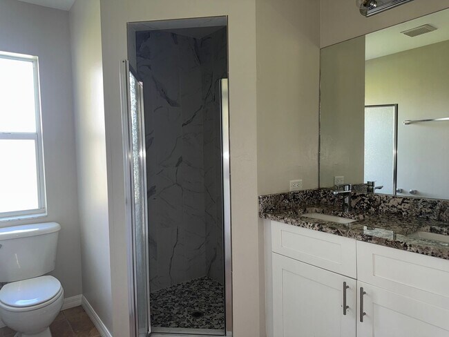 Building Photo - Experience this Cape Coral 3 bedroom 2 bath corner duplex with 1 car garage and screened in lanai.