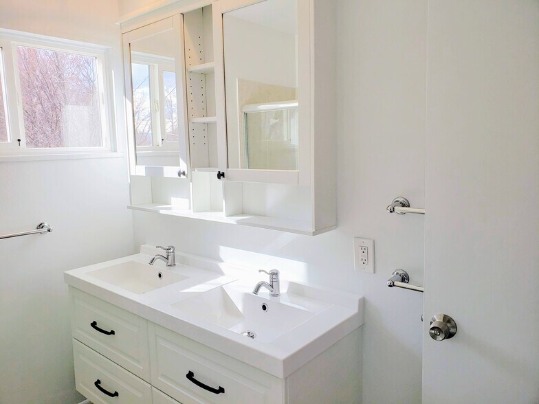 Bright and clean bathroom, newly updated with ample storage - 3155 S Fox St