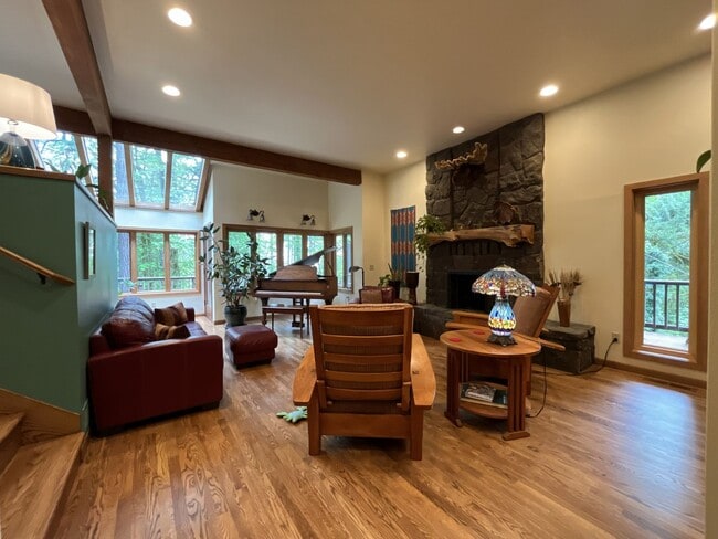 Building Photo - One-of-a-Kind Custom Home with Wall of Windows, Stone Fireplaces, Expansive Entertainment Space &...