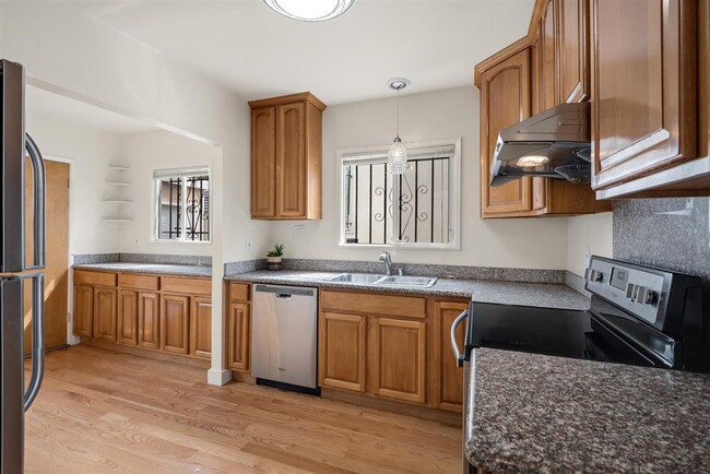 Spacious kitchen with stainless steel appliances, granite and tons of space to make this a true chef - 2108 E 23rd St