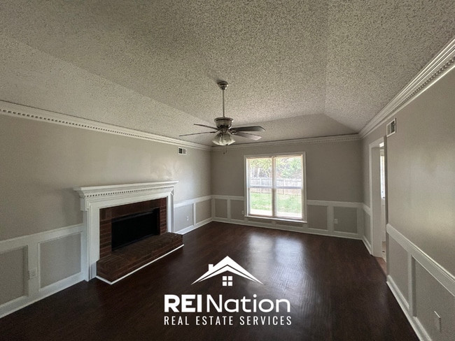 Building Photo - Spacious 4BR/2BA Near Southwind | High Ceilings, Brick Fireplace & 2-Car Garage