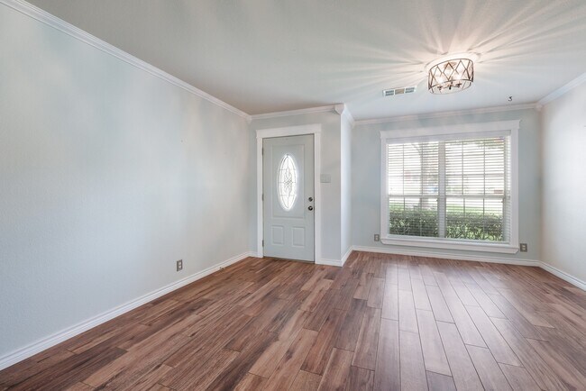 Building Photo - Modern Elegance: 3-Bedroom Townhome with Wood Flooring, Shaded Deck, and Inclusive Amenities