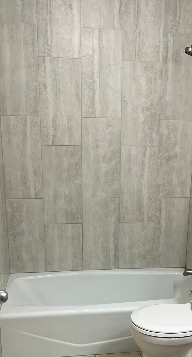 put in new ceramic tile in first floor shower/tub - 12063 Burdette Cir