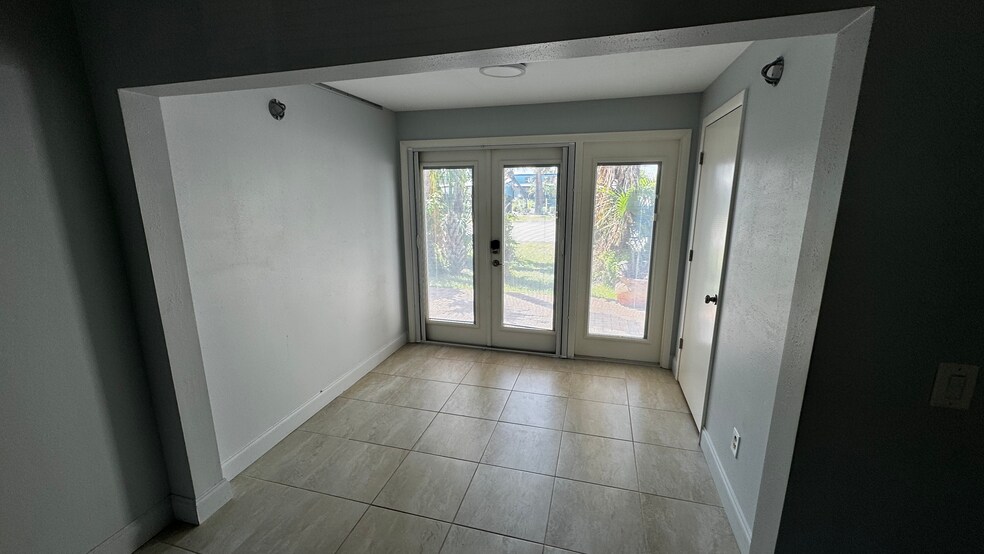 French doors to rear patio. Tons of light. - 163 Breezeway Ct