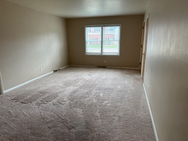 Living room. Like unit. Unit available has manufactured plank flooring - 1118 E Washington St