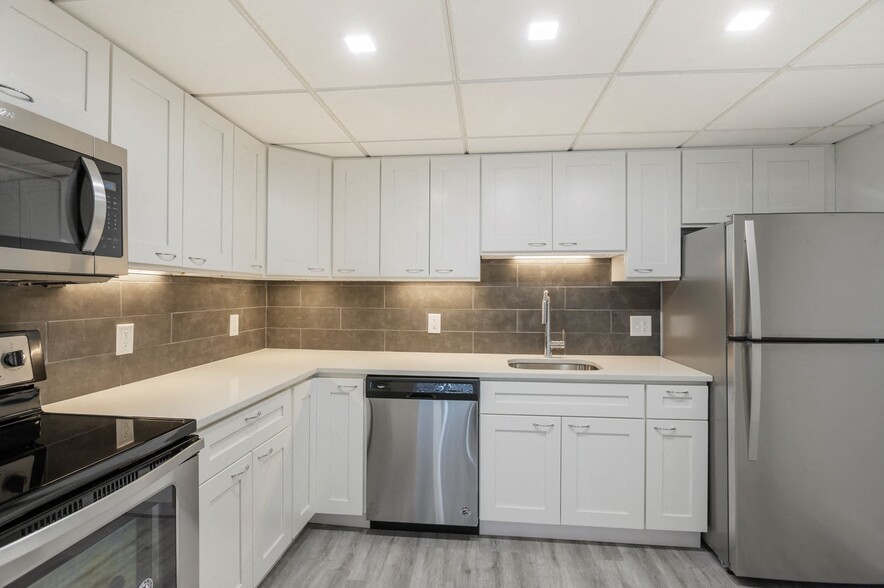 Renovated kitchen with stainless steel appliances - Lenox Club