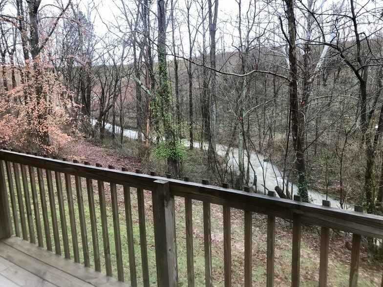 balcony view of creek that runs behind property - Eagle Creek Apartments