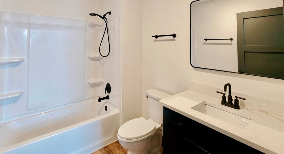 Primary ensuite bathroom. Vanity and shower/tub combo - 101 W Broadway St