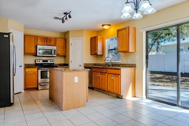 Building Photo - Spacious 4-Bed Groveland Home with Attached Garage, Central Air, and Private Patio