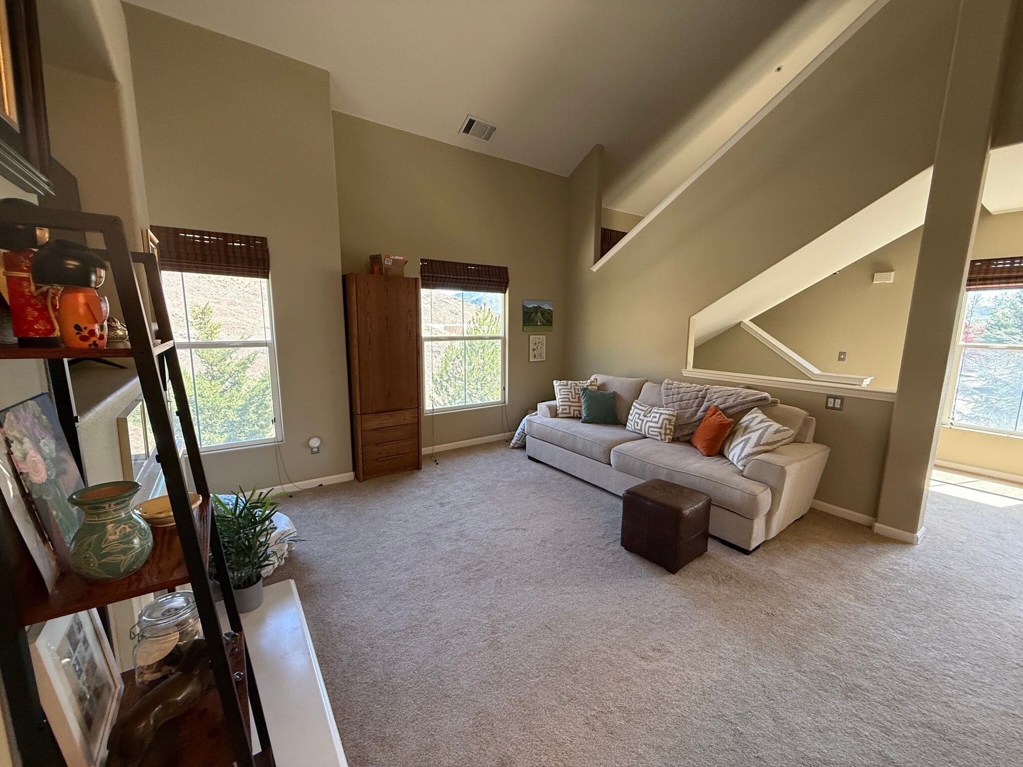 Living room showing stairs to upstairs Loft - 9050 Double R Blvd