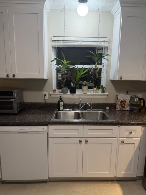 newer dishwasher and updated kitchen window that looks out to back yard - 826 Murrell Rd