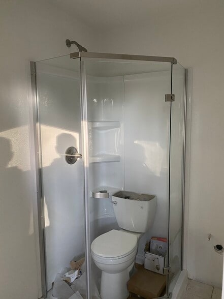 Toilet in shower just while floors are going in:) - 238 colfax ave