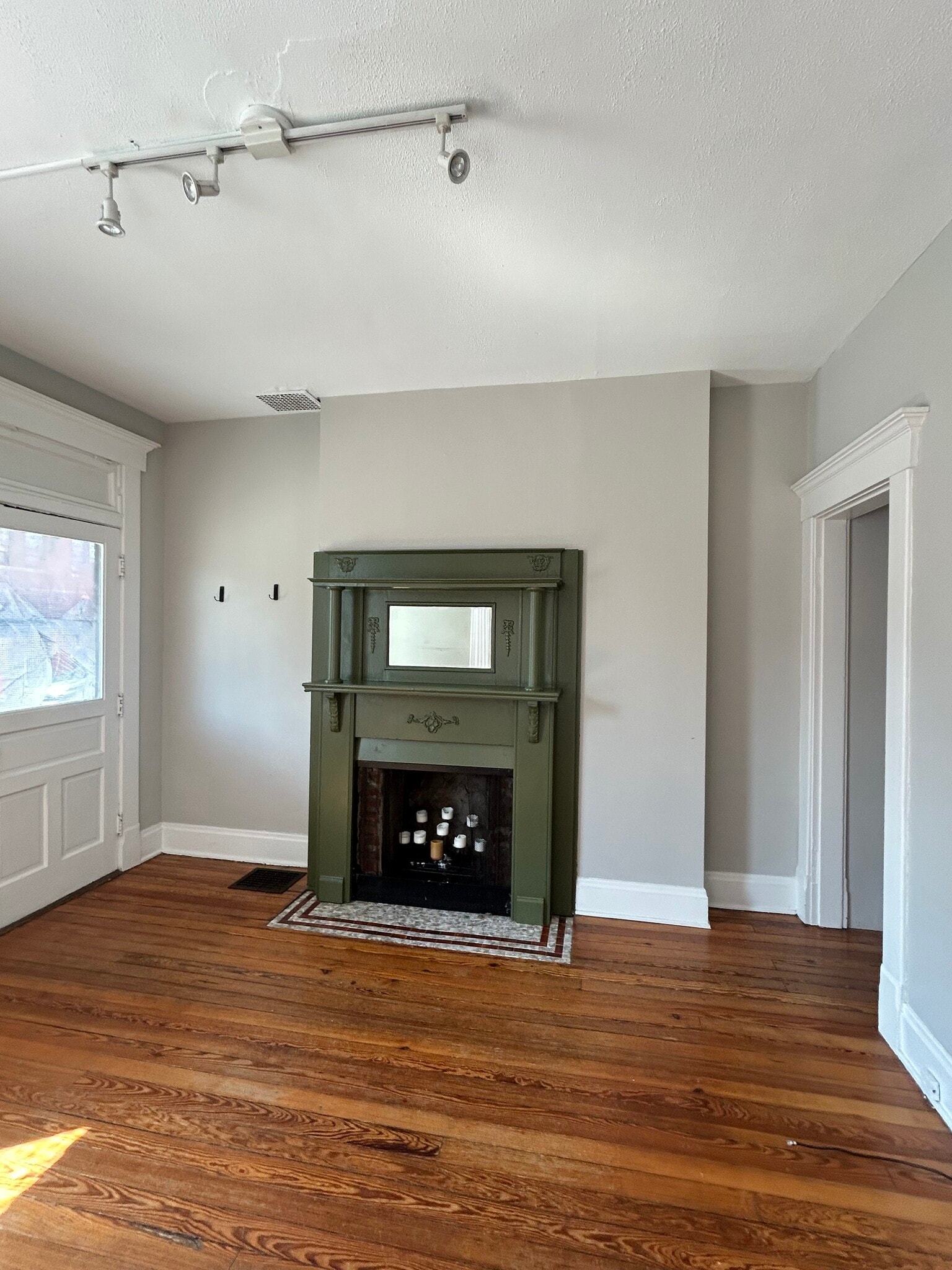 Front room with original non word burning fireplace. All original restored pine wood floors - 1152 Jaeger St