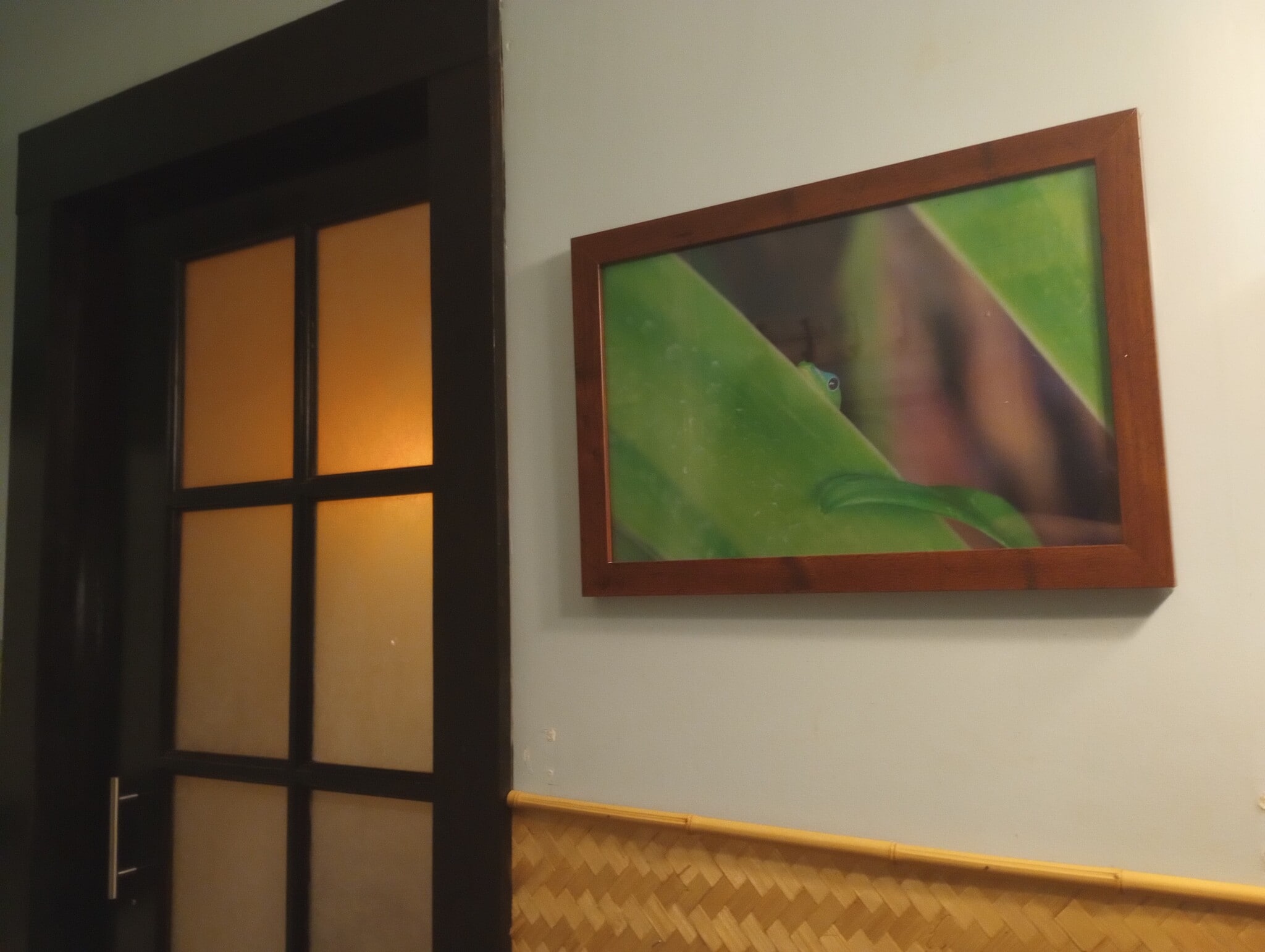 Bathroom door shown closed, local artist work - 281 Kaikea St