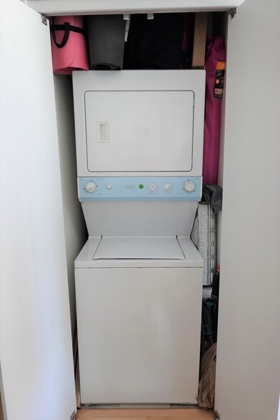 In-unit washer and dryer with ample storage space above the machine and on the sides - 1 E 8th St