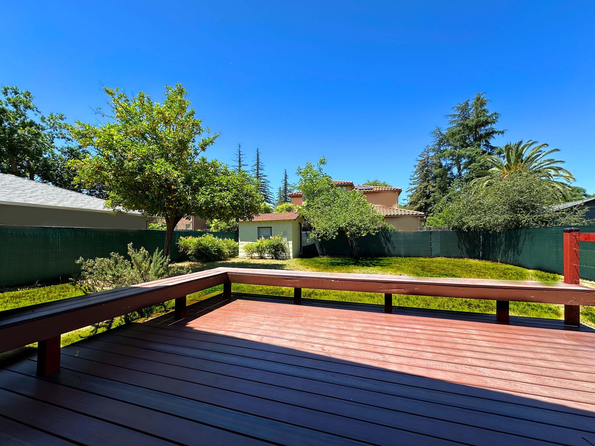 Stunning deck with built-in seating—perfect for entertaining or enjoying the backyard view. - 4570 58th St