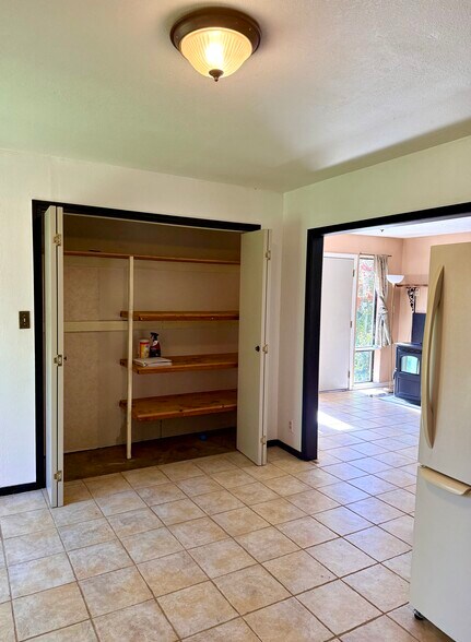 Pantry/Storage in Kitchen/Dining area looking toward pellet stove in living area - 3333 Hamblen Ct