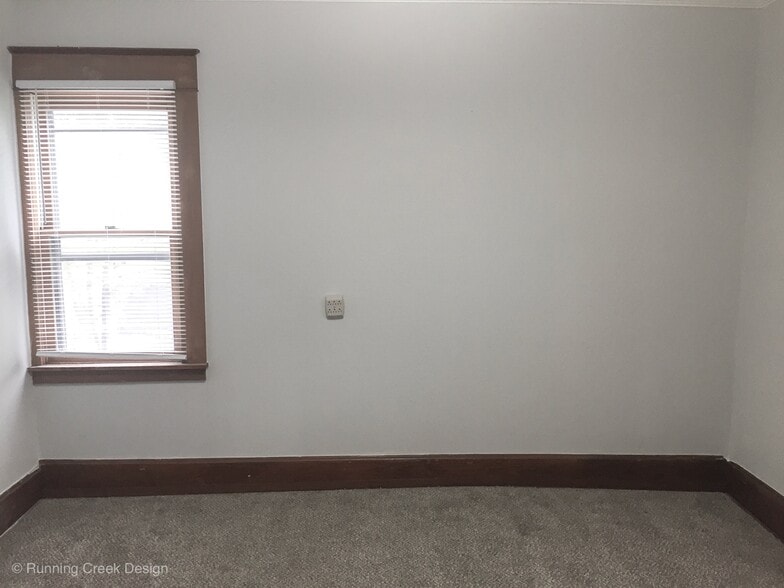 Bedroom #3 11.5 ft X 12 ft shows off the new carpet that is featured throughout the home - 328 E Walnut Street