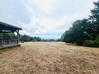 Building Photo - Majestic Farmhouse Retreat on 39 Acres with Sweeping Ocean Views