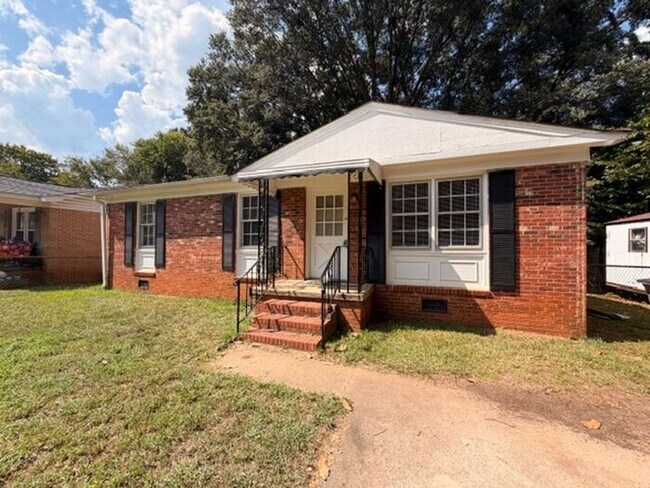 Building Photo - Three bedroom brick home available now!