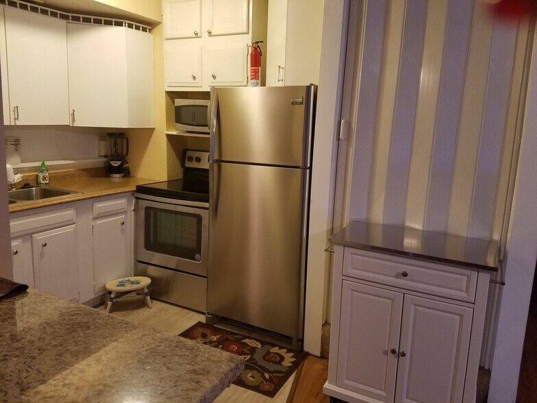 Kitchen and Granite sitting area, extra storage beyond door. - 2110 Tudor Hills Ct