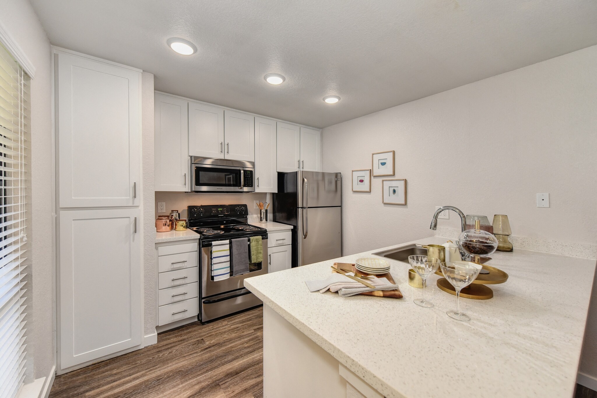 Kitchen with White Cabinets & Pantry - The Brighton Apartments