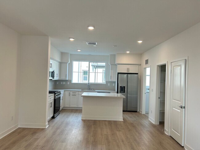 Building Photo - Gorgeous, 3 level townhome, featuring 2 car garage central Air, and in Unit laundry.