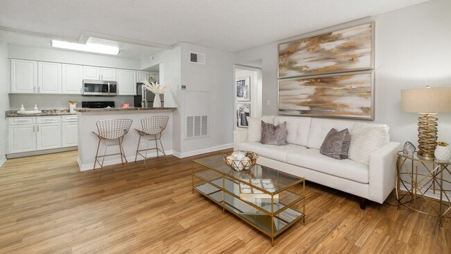 Enjoy effortless entertaining with this open layout, featuring wood-style flooring and soft neutral tones. - Ashton Chase