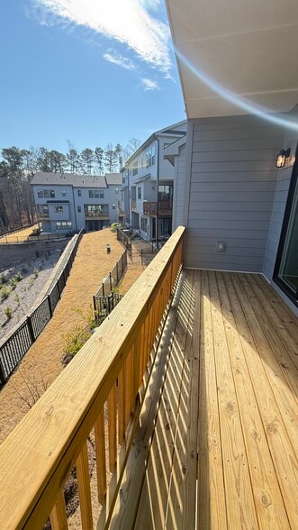 Elevated balcony overlooking mature trees and green space. - 4720 Cypress Tree Ln